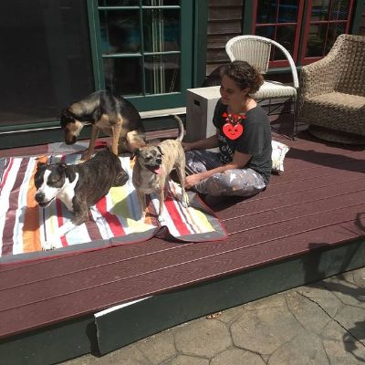 Photo of Kim Caramele along with her three dogs.